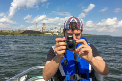 man on boat holding camera